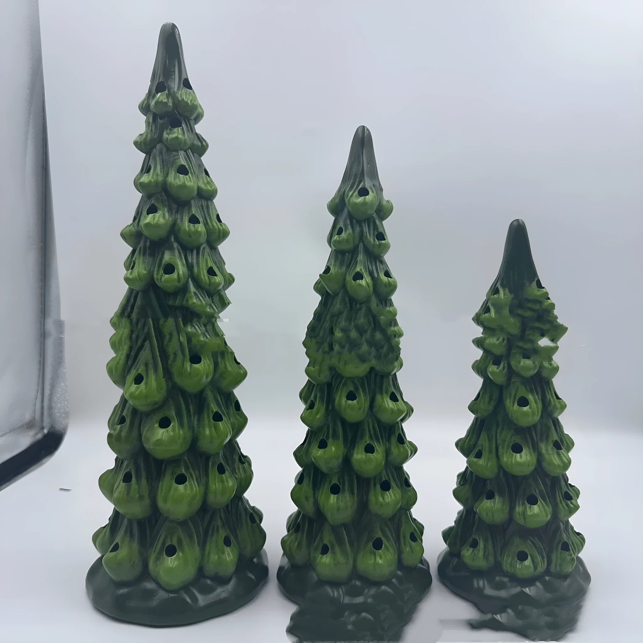 A decorative resin Christmas tree ornament with built-in LED lights, shown in European style.