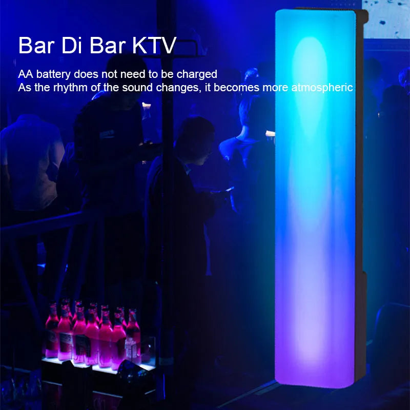 Black and white 3D RGB voice-activated music rhythm ambiance lamp on a tabletop.