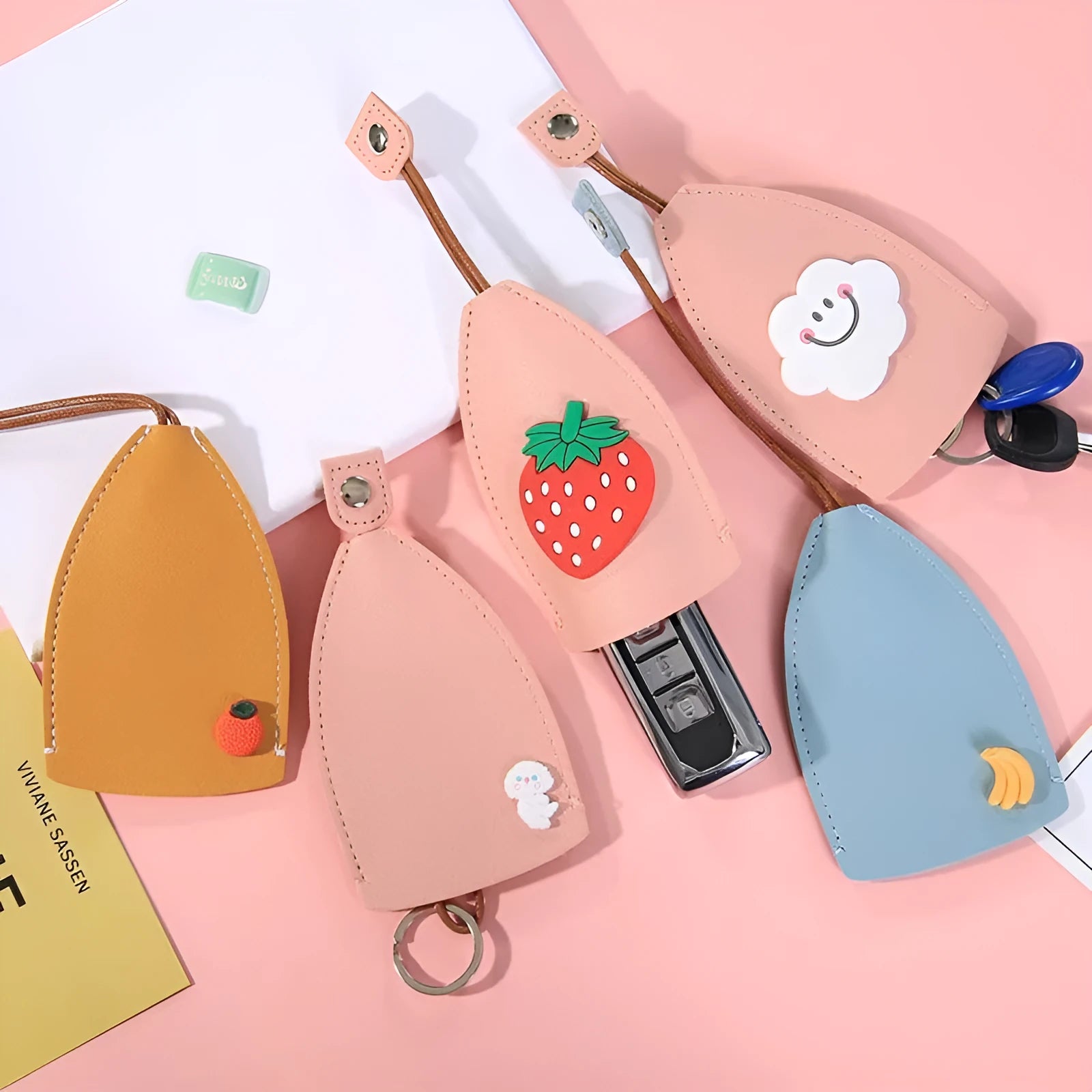 Cartoon pull-out key case in PU leather showing design options including resin fruit and big cartoon animal prints.