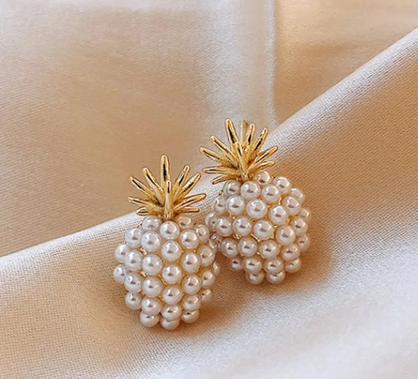 Gold Korean-style alloy earrings with pineapple starfish design and pearl-coloured gem inlays.