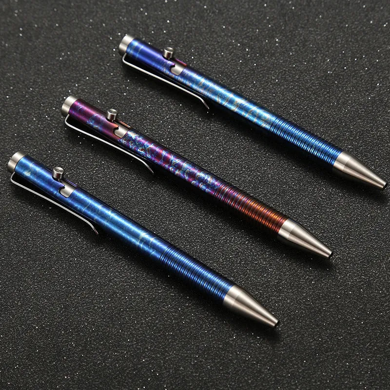 Titanium alloy gun bolt handle ball pen with a randomised phantom colour finish on a dark background.