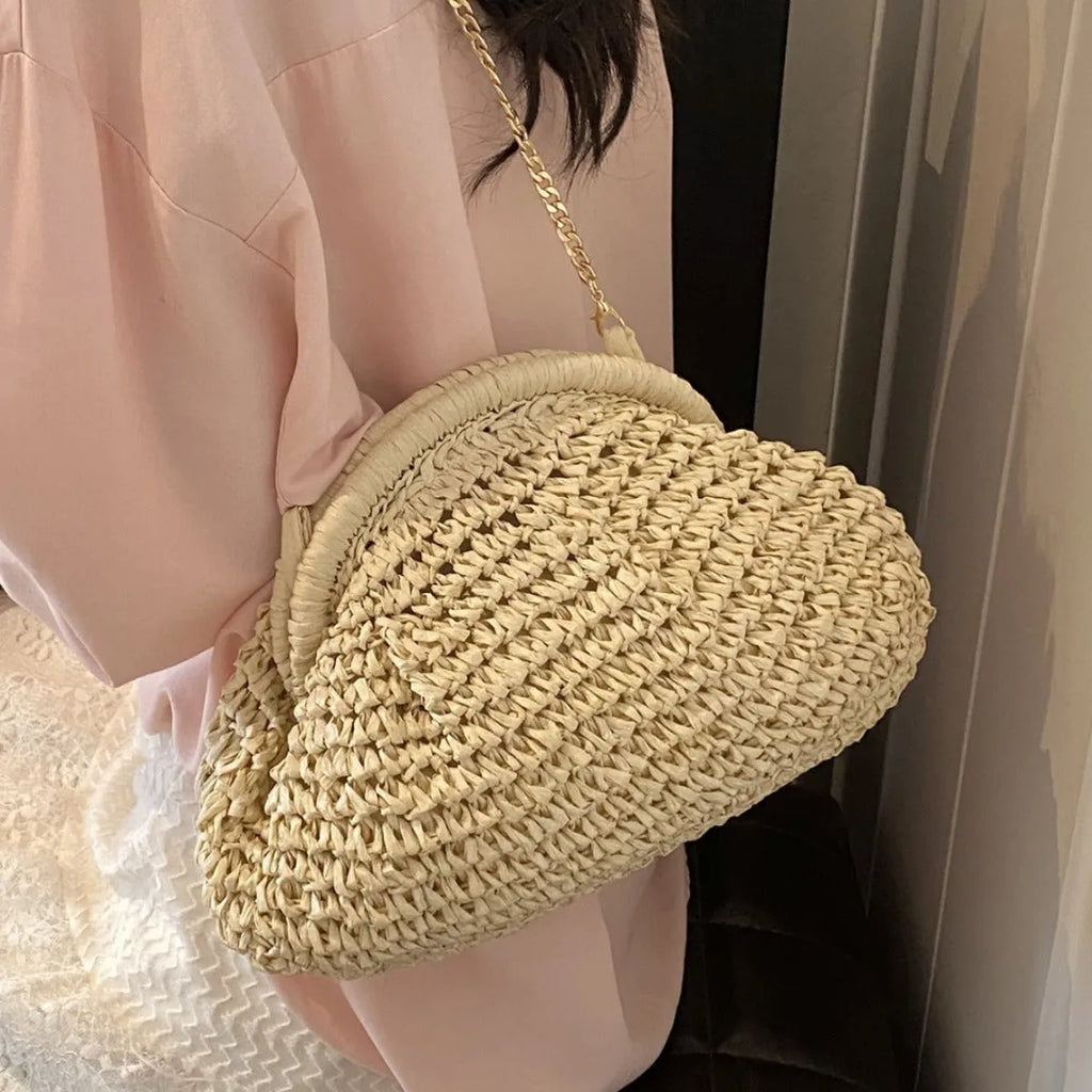 Women's straw beach shoulder bag in khaki colour with chain detailing and shell shape