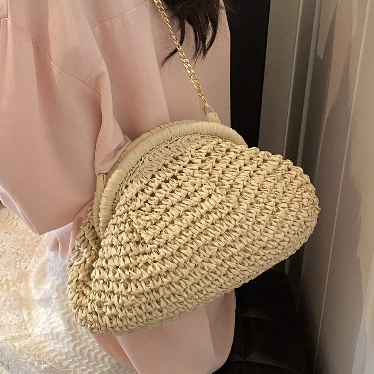 Women's straw beach shoulder bag in khaki colour with chain detailing and shell shape