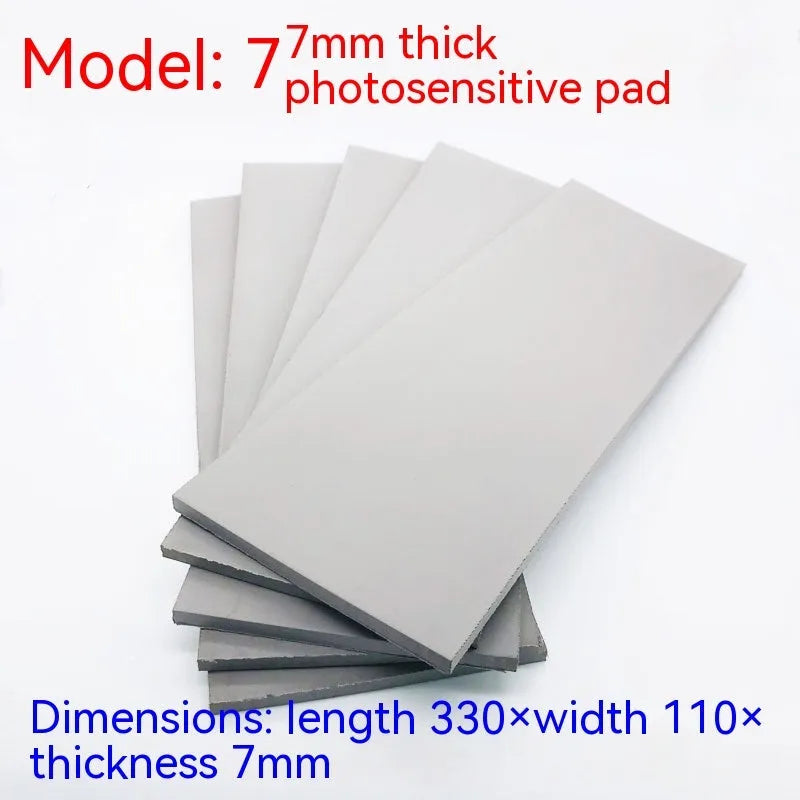 Black and grey plastic light-sensitive mat for creating seals, showing size and thickness options.
