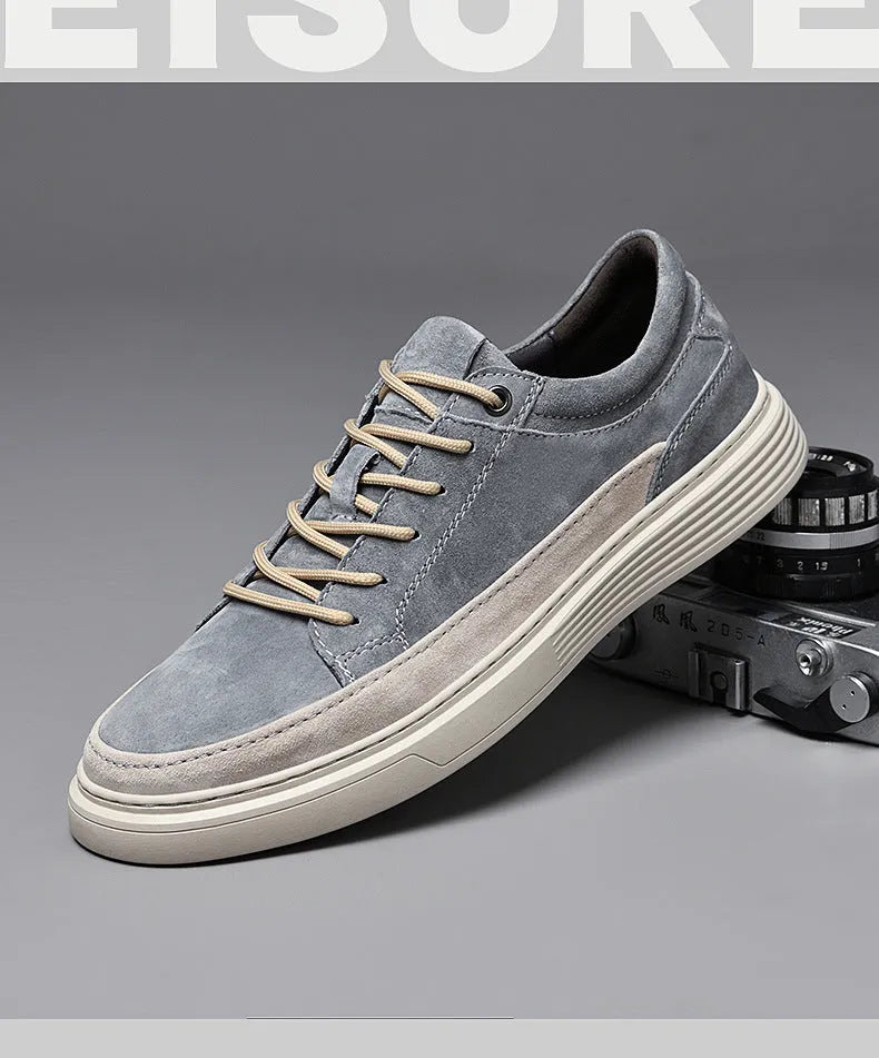 Men's grey low-top pigskin leather skate shoes with flat rubber sole and lace-up front.