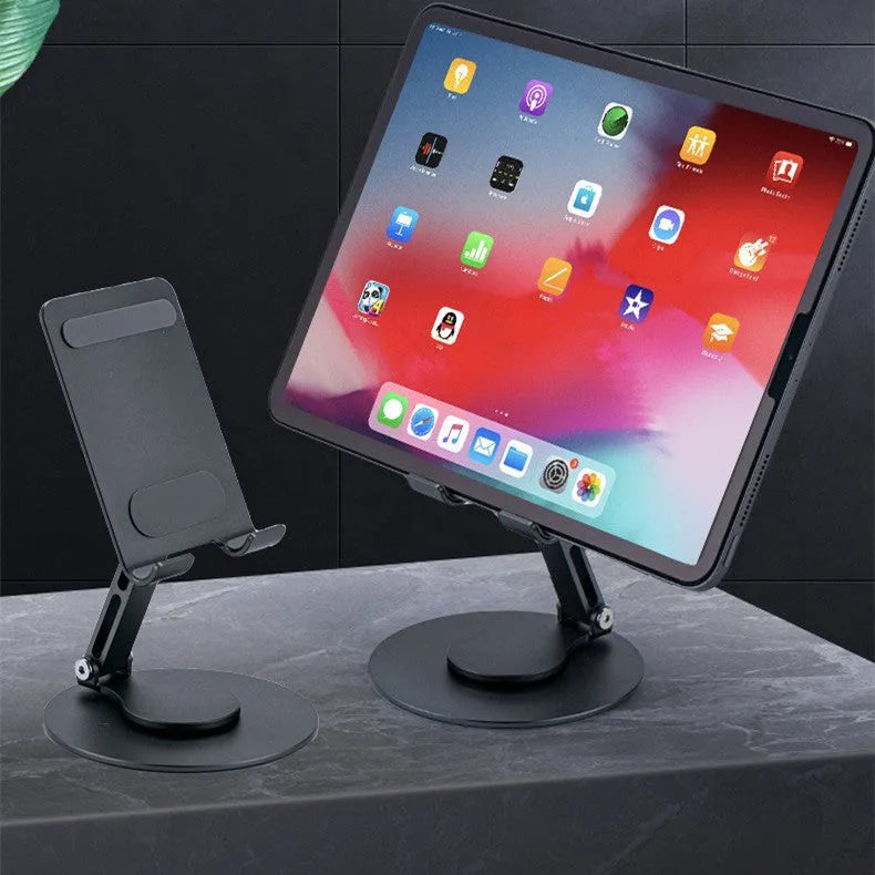 Aluminum alloy rotating mobile phone bracket in grey with silicone grip on desk showing phone in portrait mode