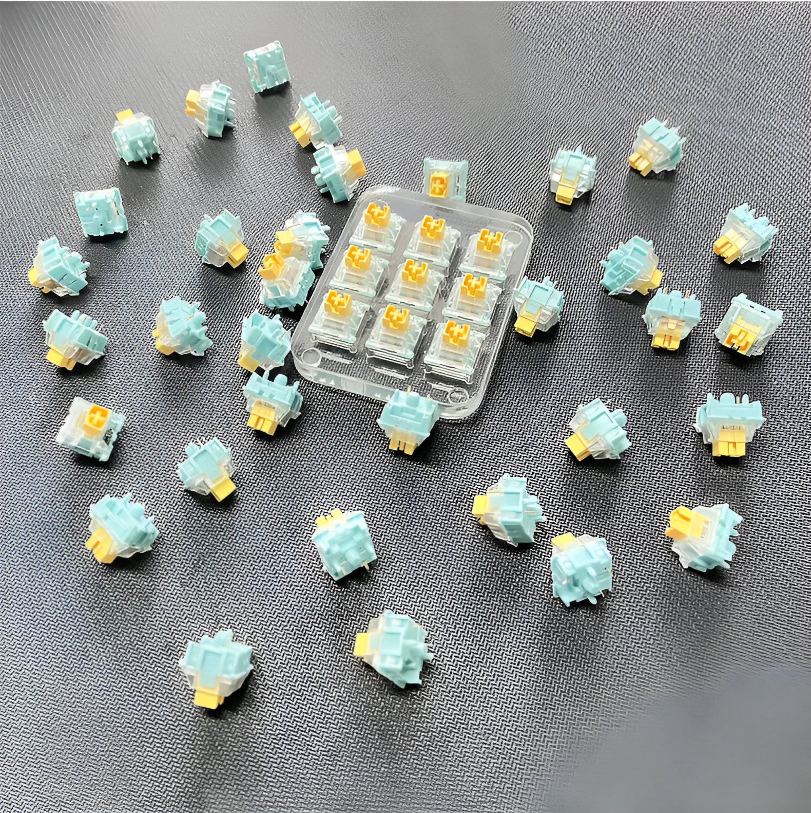 36 Sea Salt Lemon PRO Mute mechanical keyboard switches with transparent housings on a white background.
