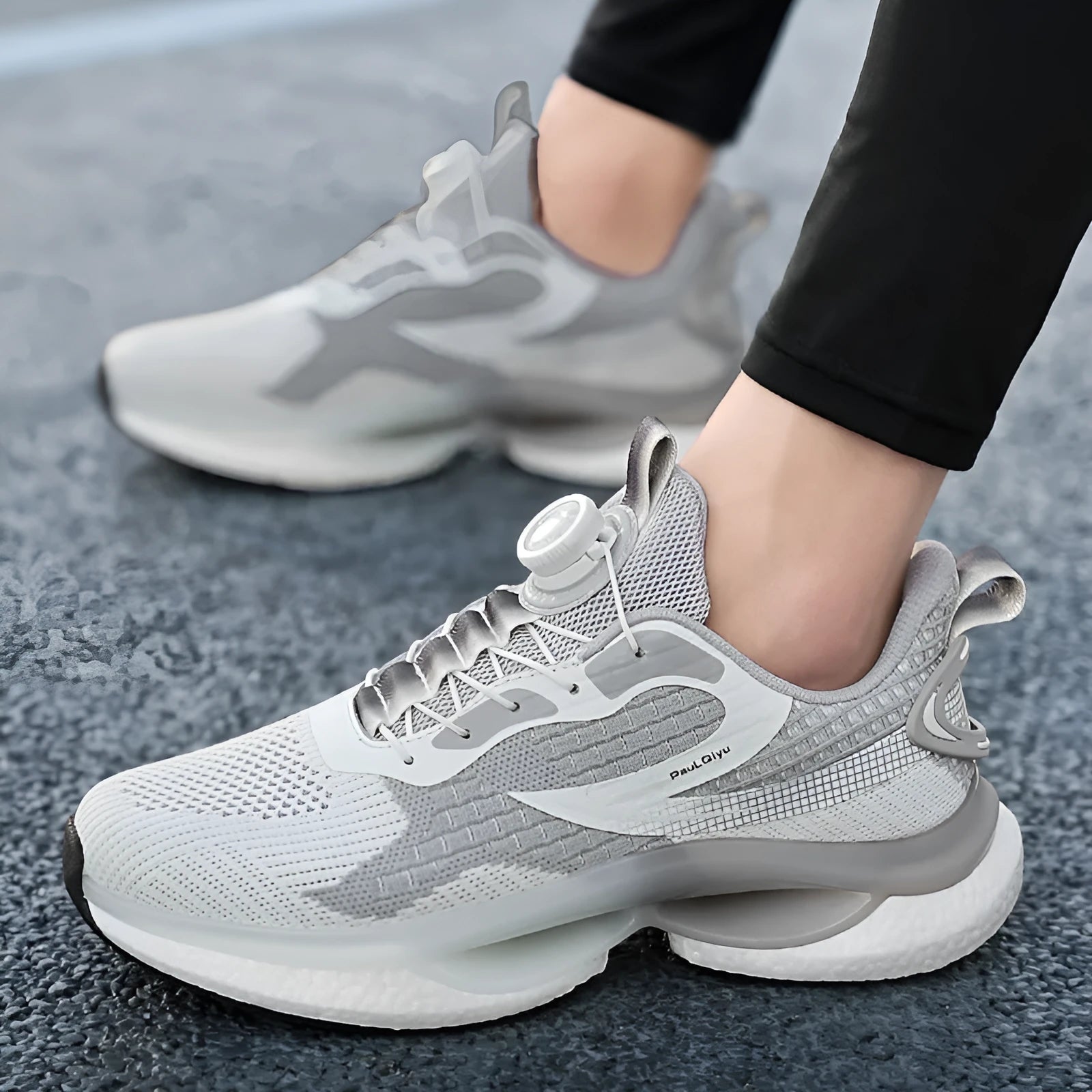 Low-top men's running shoes with buckle closure in solid colours showing Fly-knit mesh upper and TPU soles