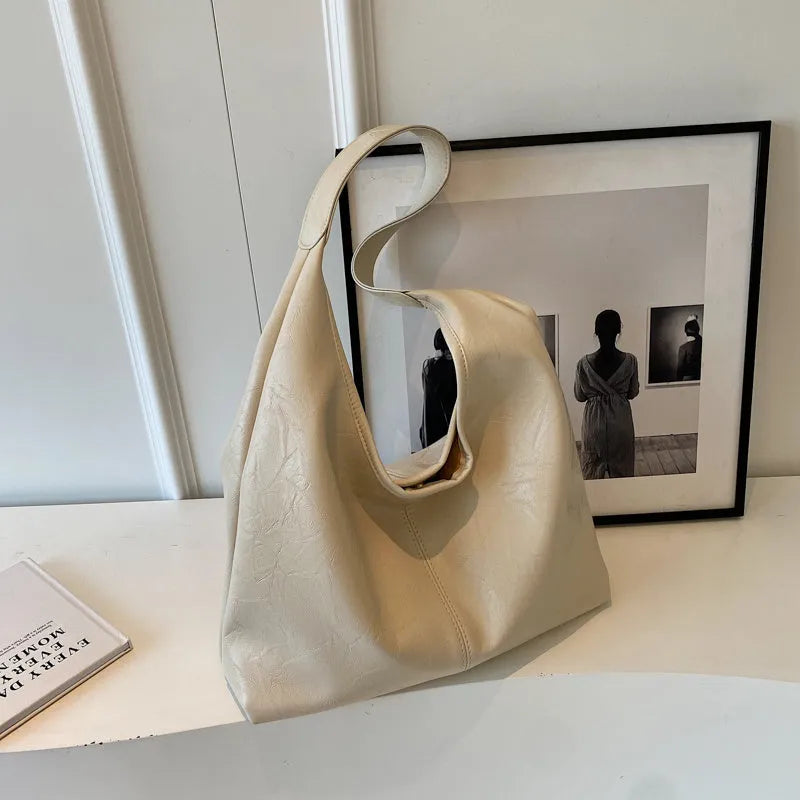 Soft leather shoulder bag in street style with sandwich pockets, shown in multiple colour options.