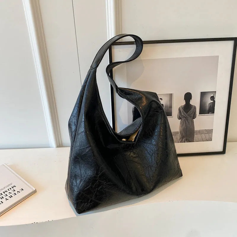 Soft leather shoulder bag in street style with sandwich pockets, shown in multiple colour options.