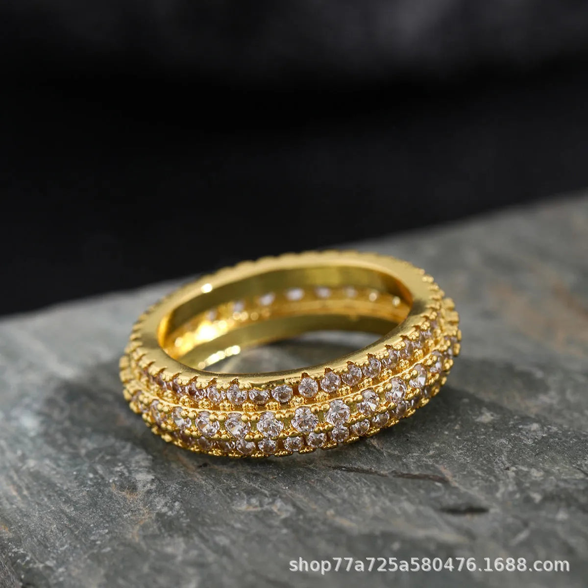 Geometric gang drill style engagement ring with a triangular zircon stone inlay on a metal band.