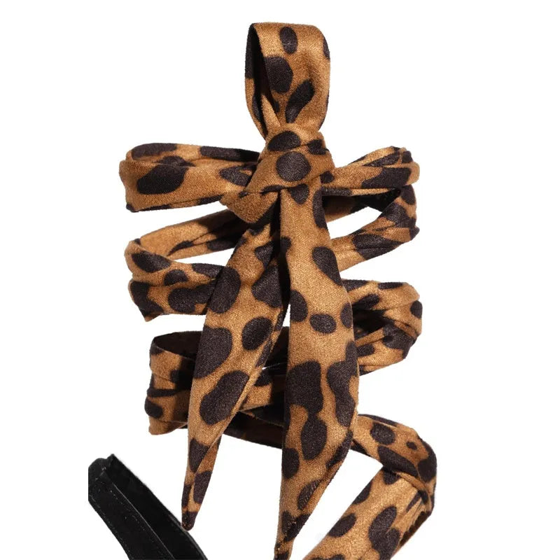 Light brown leopard print Roman style high heels with cross straps and super high heel