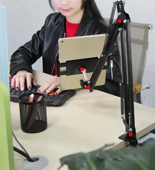 Black and white adjustable phone and tablet stand on a desk at 10cm height