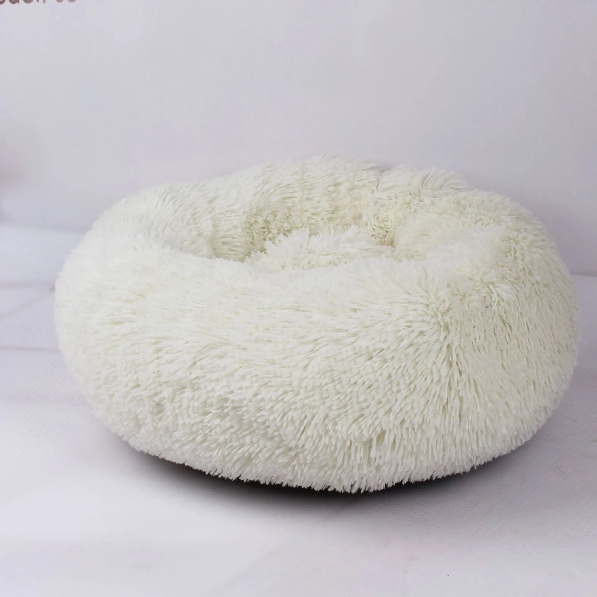 Plush pet nest in apricot colour on floor, soft cloth circular dog bed 40cm diameter indoor use