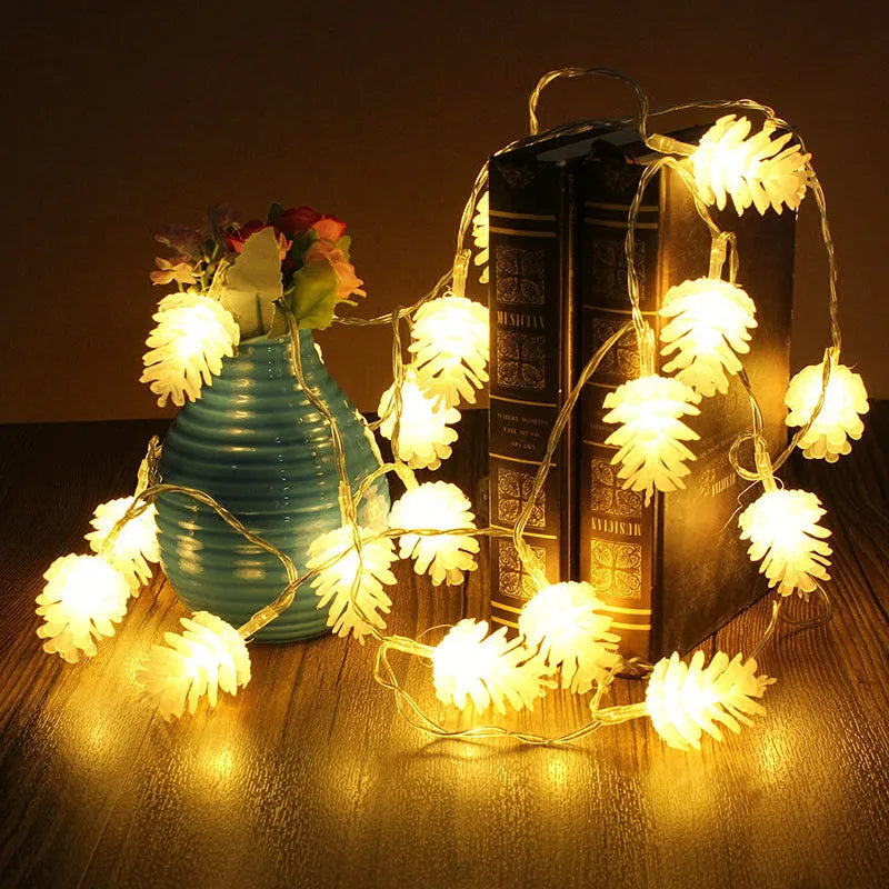 Warm white plastic pine cone LED light string powered by batteries on a dark background.