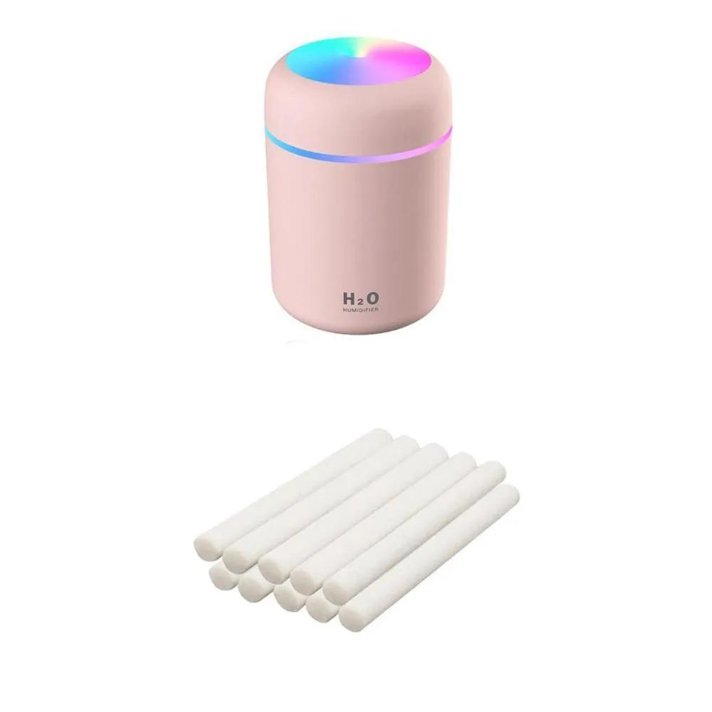 Pink USB portable humidifier with 300ml water tank on wooden desk surface