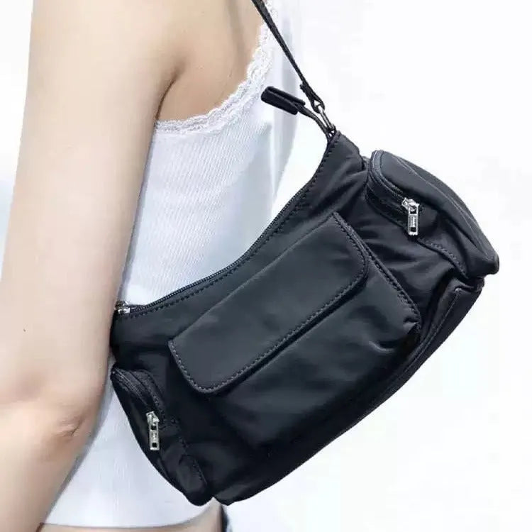 Black PU women's shoulder bag with two pockets, side-line detail, and a nylon lining.