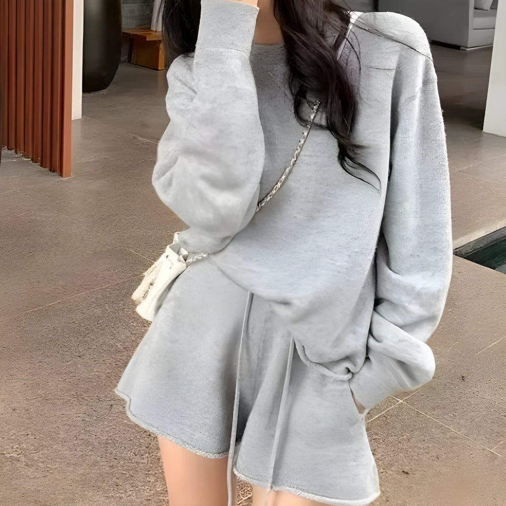 Women's knitted two-piece set showing long sleeve sweater with wide leg shorts in oatmeal colour