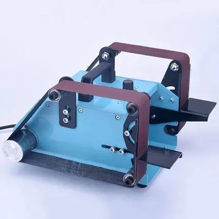 Blue desktop dual-axis belt sander for sharpening knives and sanding, showing the motor, belt, and variable speed switch.
