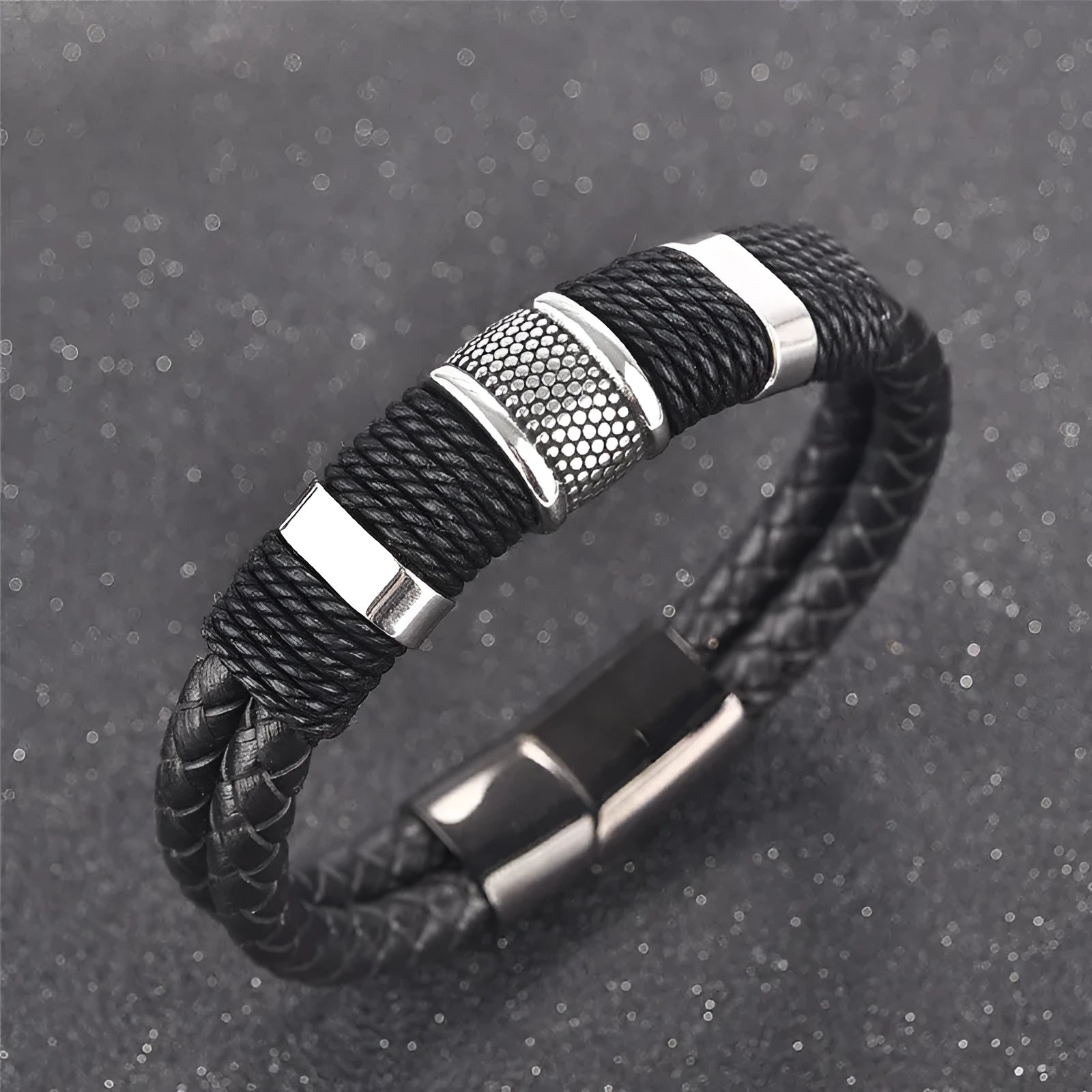 Black braid woven leather bracelet with titanium stainless steel accents for men on a neutral background
