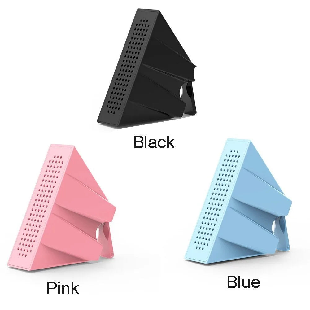 Compact black mobile phone amplifier bracket holding an iPhone on a desktop.