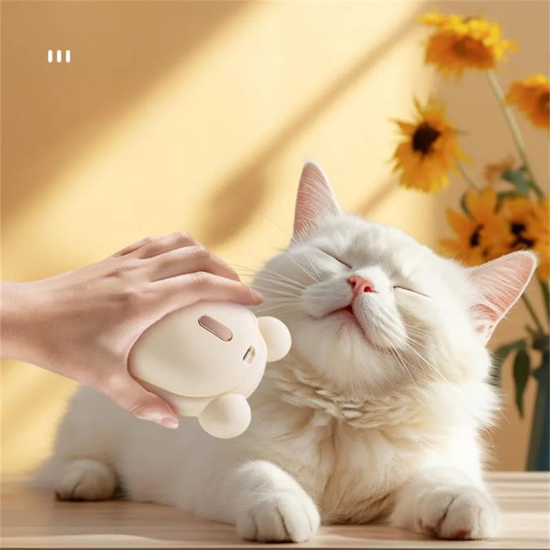 Pink and yellow rechargeable pet grooming spray brush with removable silicone comb head.