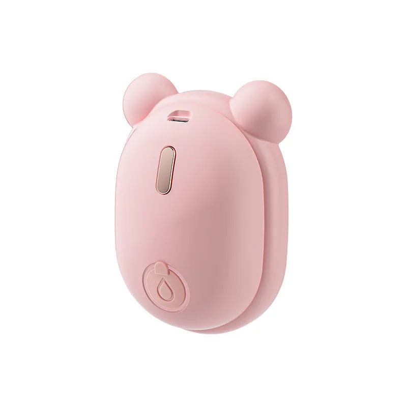 Pink and yellow rechargeable pet grooming spray brush with removable silicone comb head.