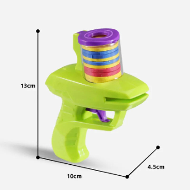 Green interactive cat toy launcher with three white foam discs on a carpet.