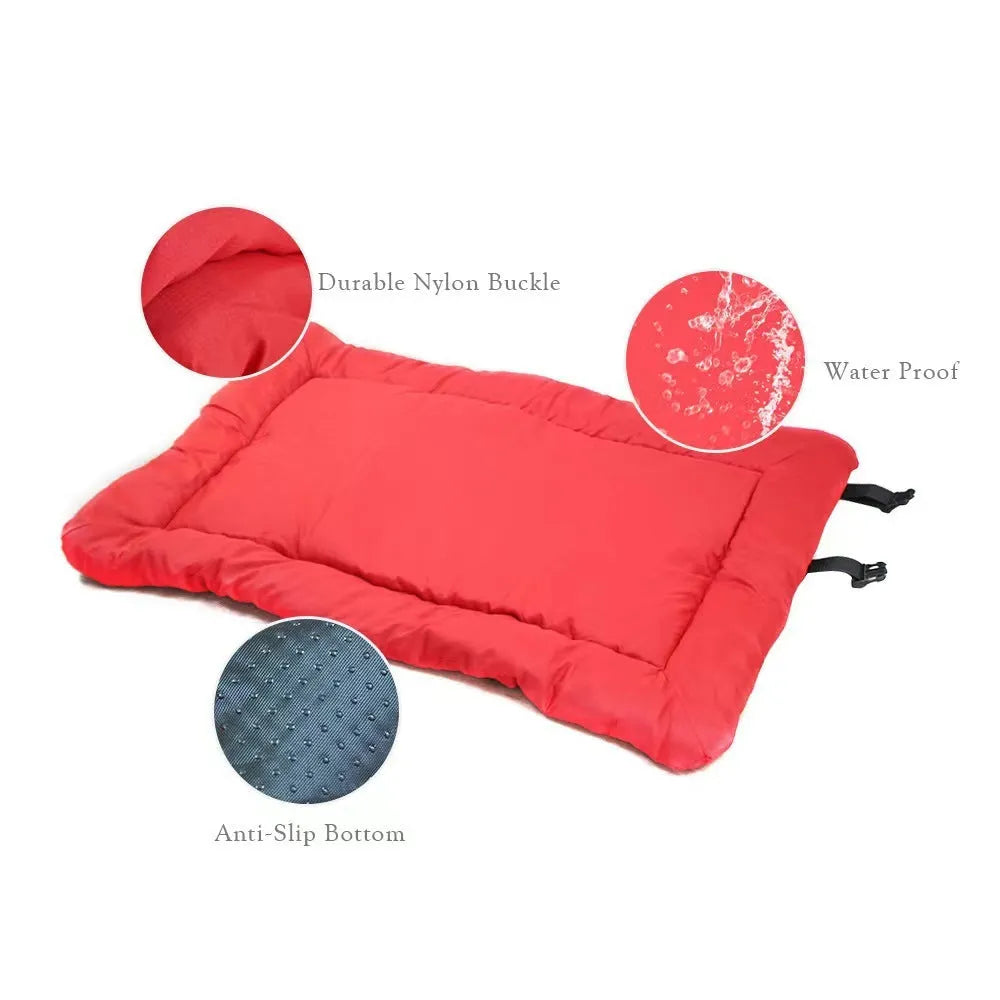 Blue folded portable dog bed with nylon buckles next to an unfolded bed on grass.
