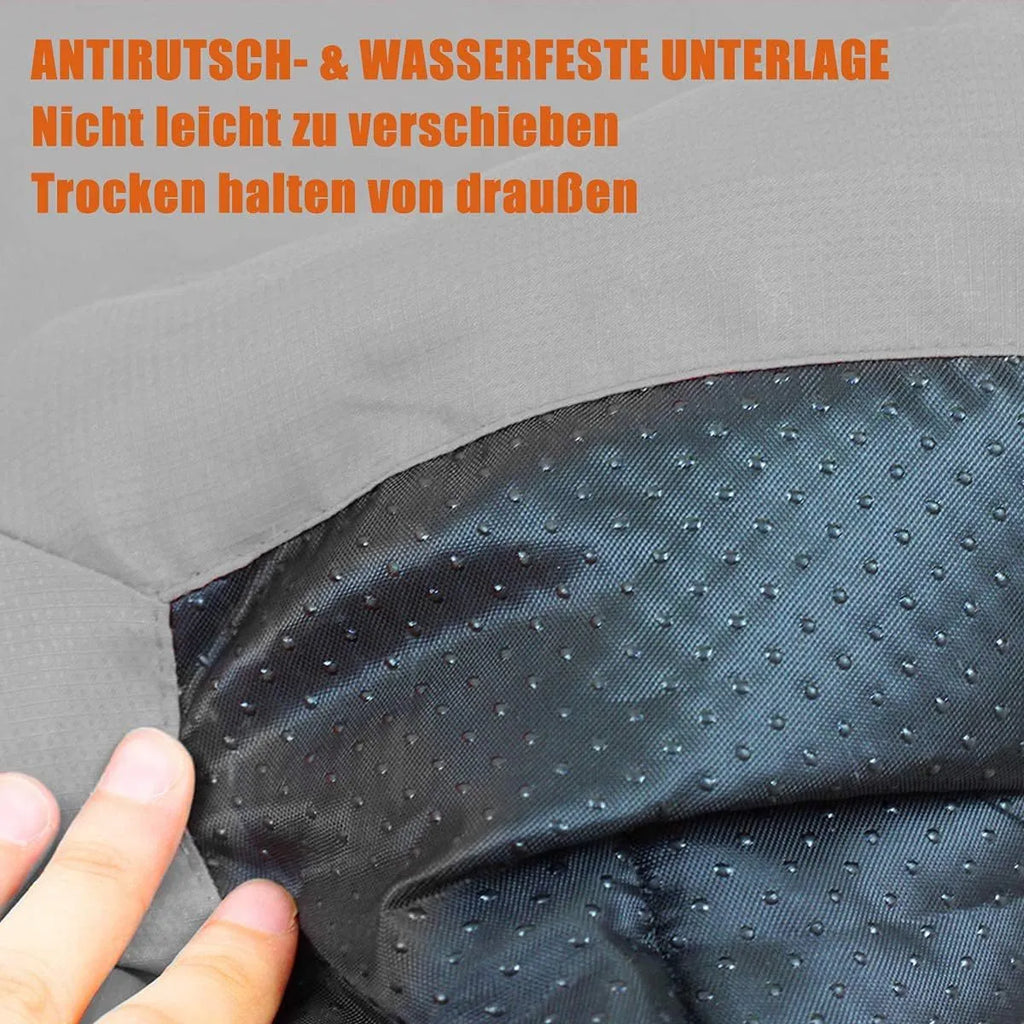 Blue folded portable dog bed with nylon buckles next to an unfolded bed on grass.