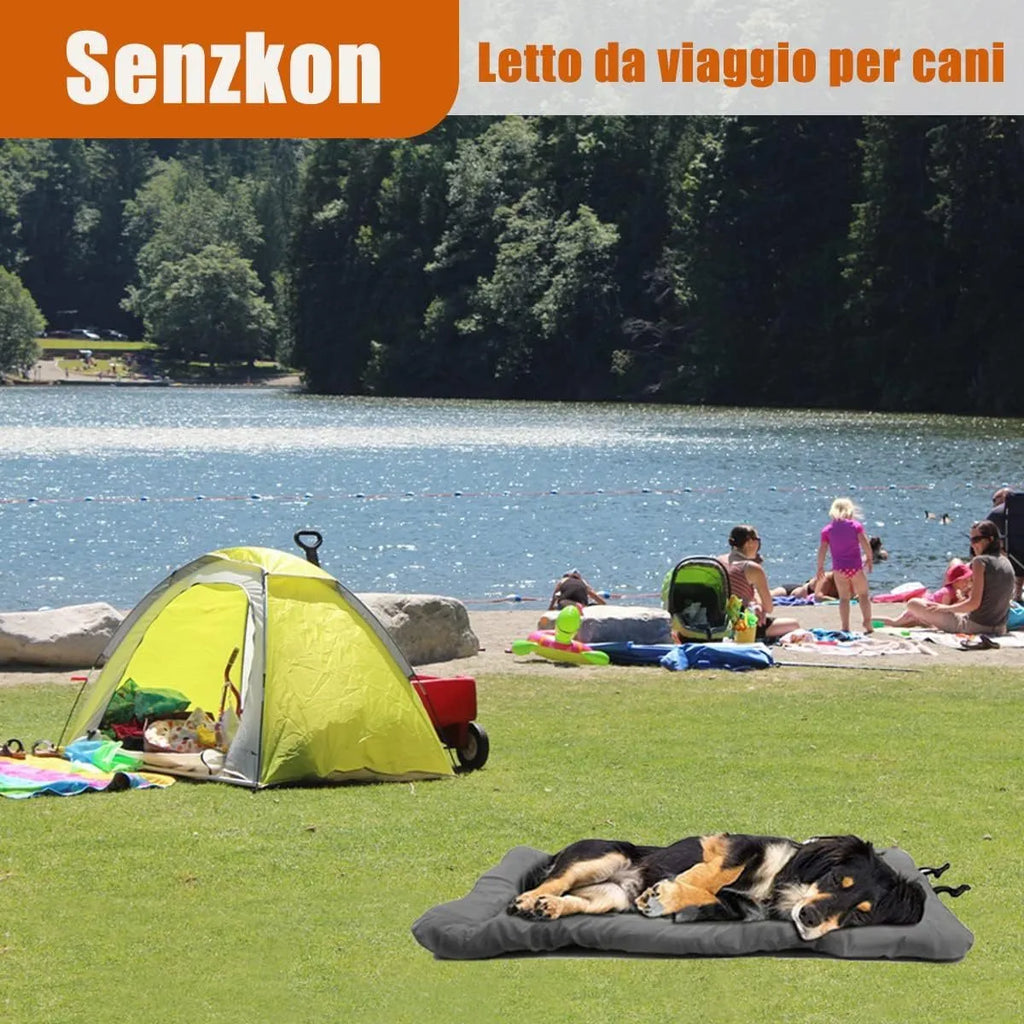 Blue folded portable dog bed with nylon buckles next to an unfolded bed on grass.