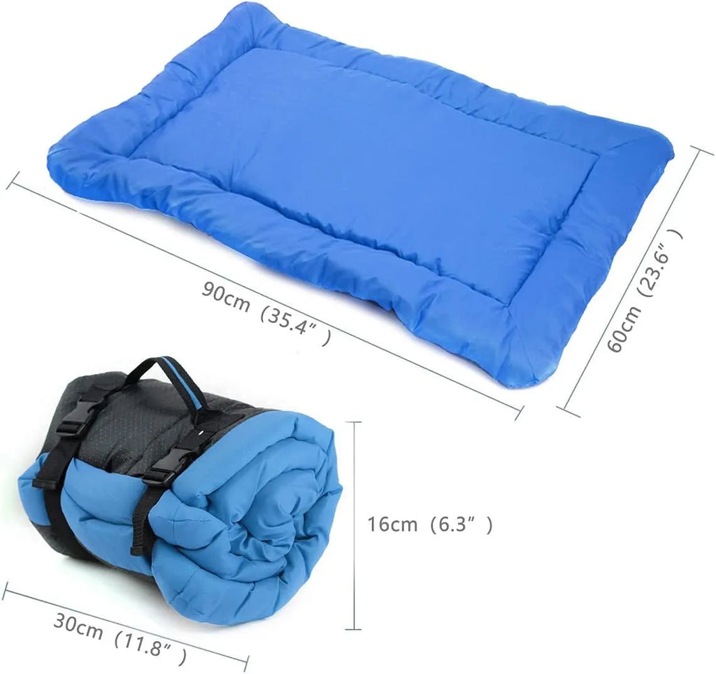 Blue folded portable dog bed with nylon buckles next to an unfolded bed on grass.