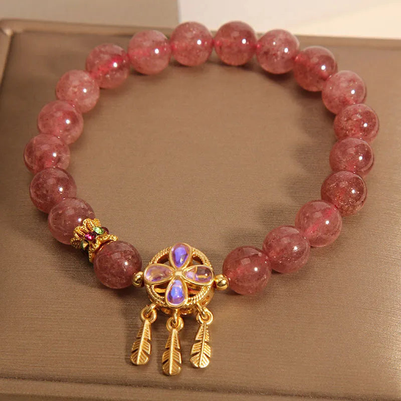 Women's strawberry quartz bracelet with four-leaf dream catcher pendant in natural crystal tones