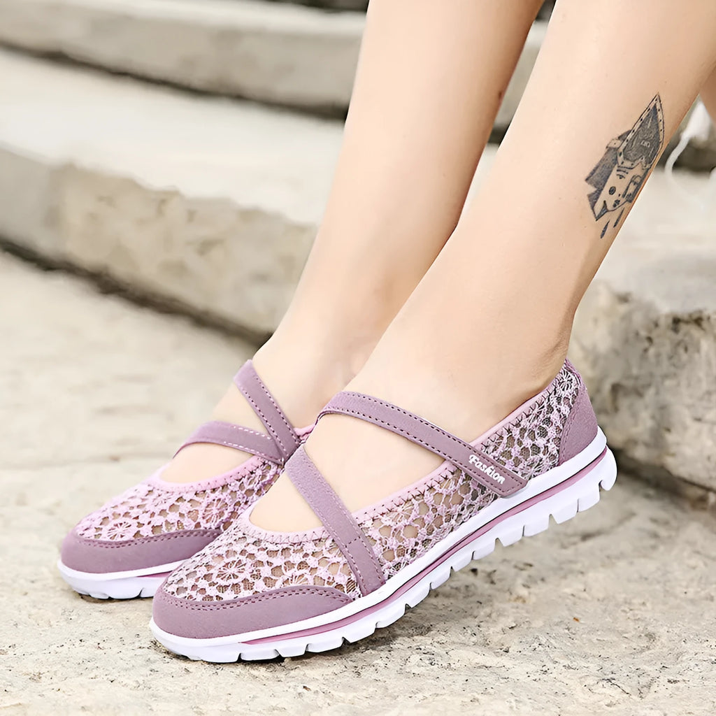 Women's beige lace-up casual flats with mesh upper and round toe on a light background.