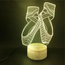 3D acrylic ballet shoe night light with colourful LED illumination on ABS base, remote control beside it