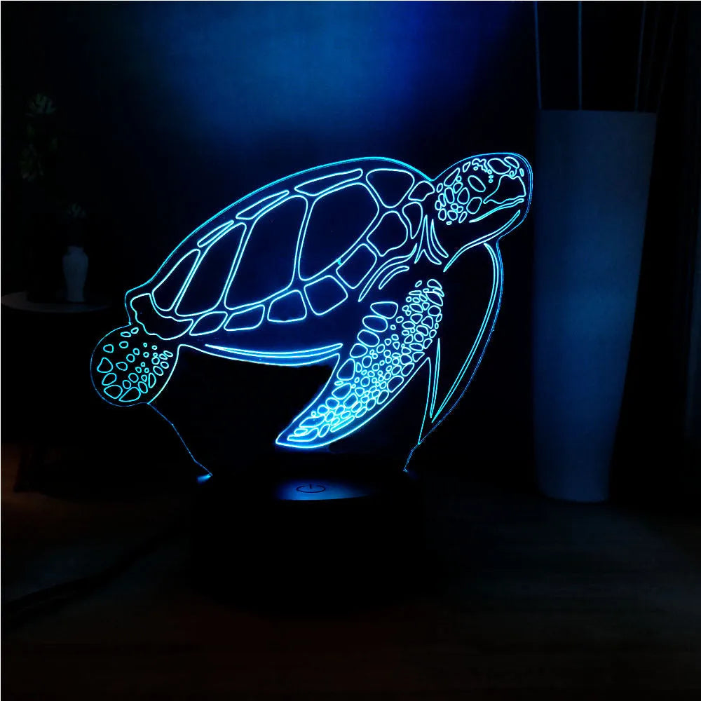 3D green turtle shaped LED night light glowing with multi-colours on a wooden table.