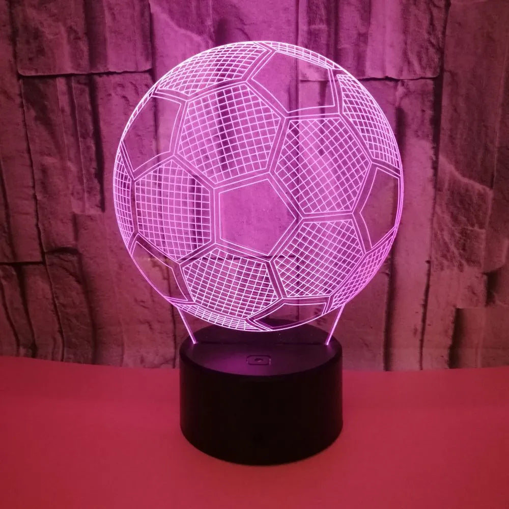 3D football-shaped LED night light showing colour gradient on acrylic panel with touch control base.