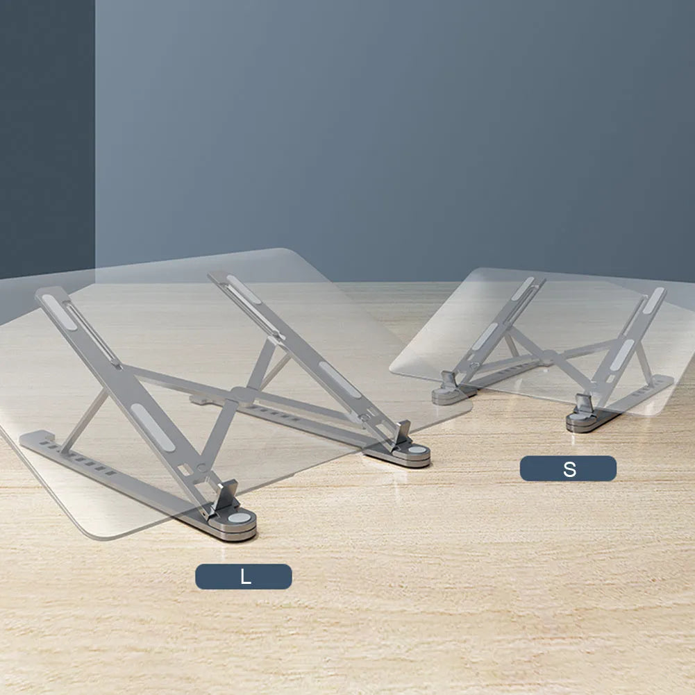 A folded silver aluminium laptop stand next to an open laptop, showing its thin profile and adjustable angle mechanism.