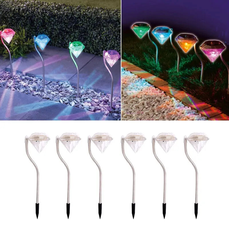 White solar-powered garden spotlight with adjustable head and solar panel on a stake for outdoor installation.