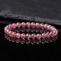 Women's strawberry quartz crystal bracelet with polished beads in three size options.
