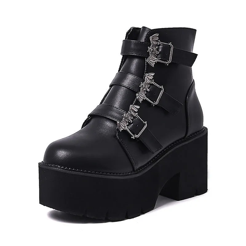 Black women's gothic punk ankle boots with a large bat-shaped buckle and a side zipper.