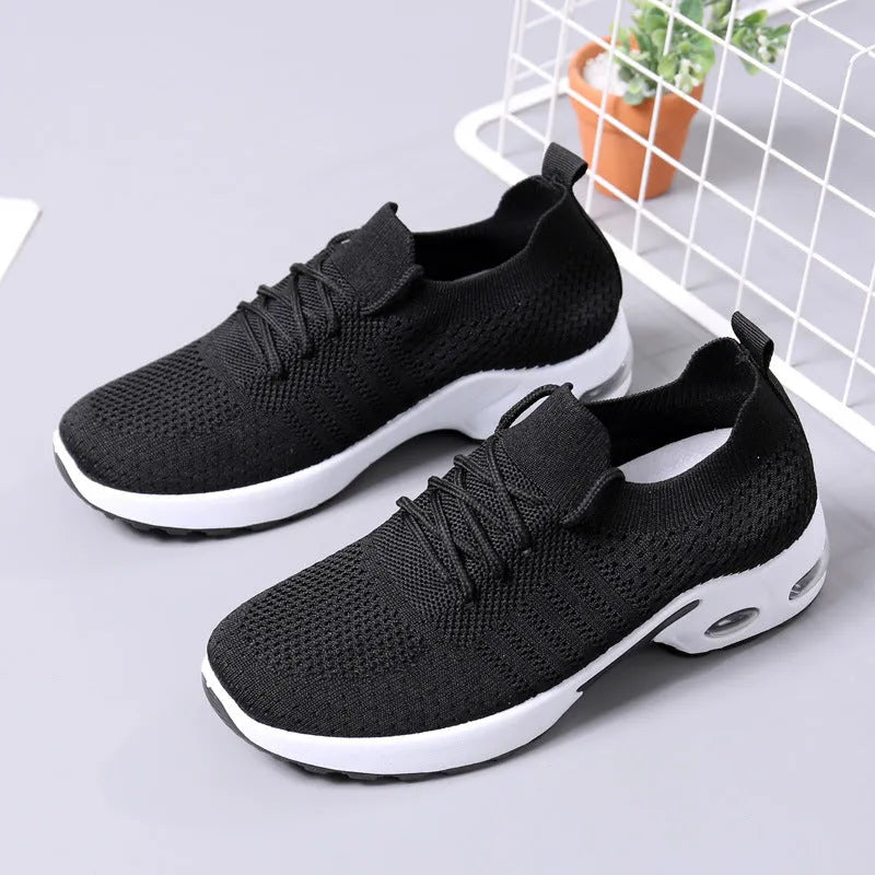 Women's black casual sneakers with mesh upper and non-slip PVC soles, shown with lace-up front closure