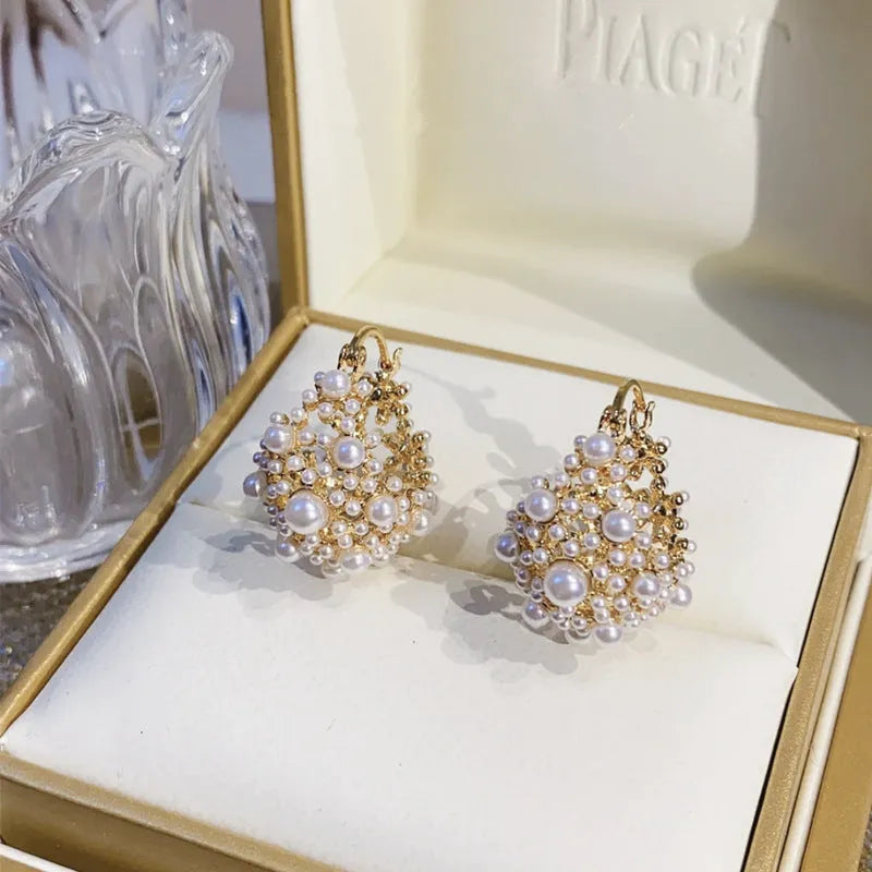 Women's gold-coloured copper flower basket earrings with small bead detailing and pearl inlay treatment