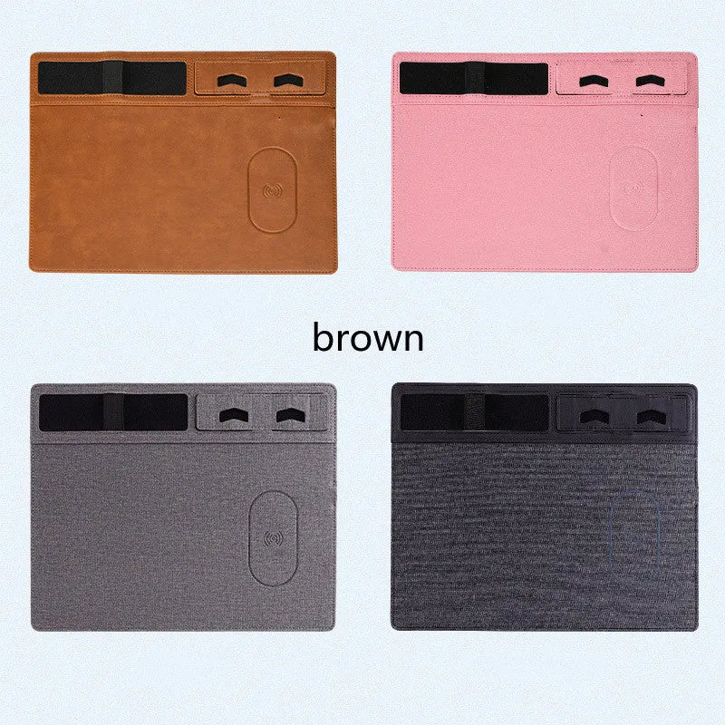 Large pink wireless charging mouse pad with integrated mobile phone holder on a desk.