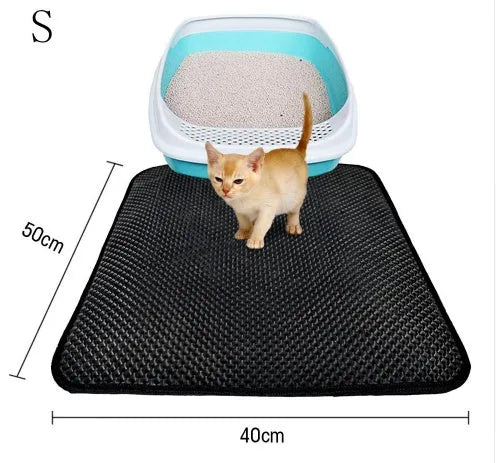 Double layer EVA cat litter mat in black with textured surface, placed under a litter box to trap debris