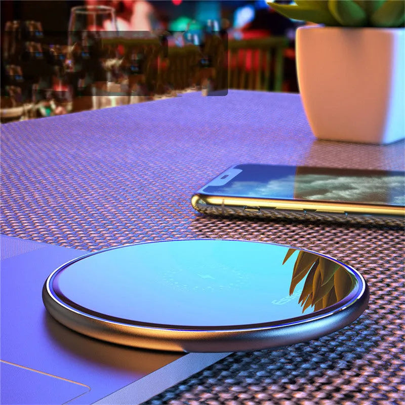 Black and white aluminium wireless charger showing LED indicator lights and anti-slip surface
