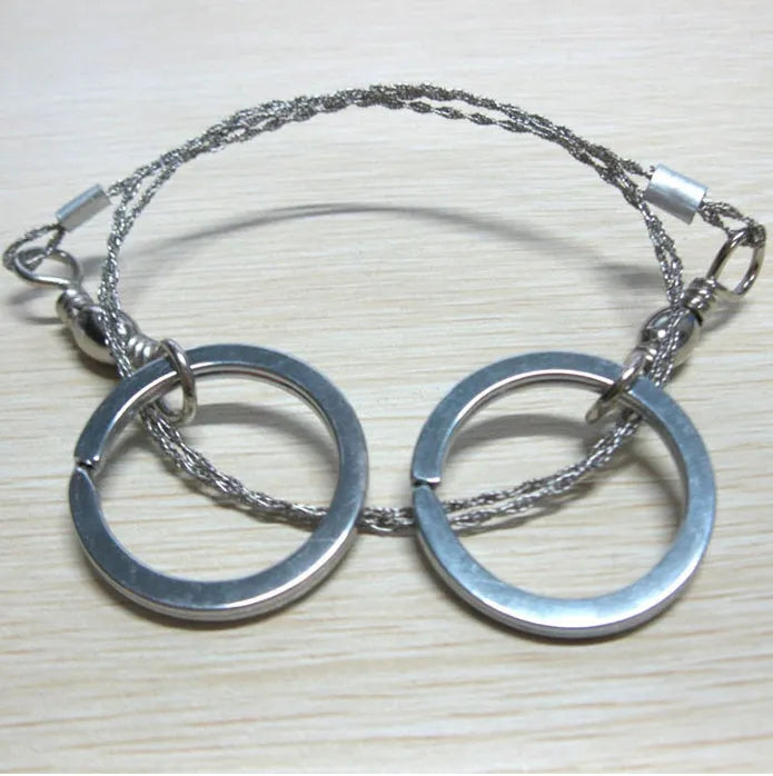 Survival wire saw with stainless steel blade and finger loops, showing 55cm length and pull ring