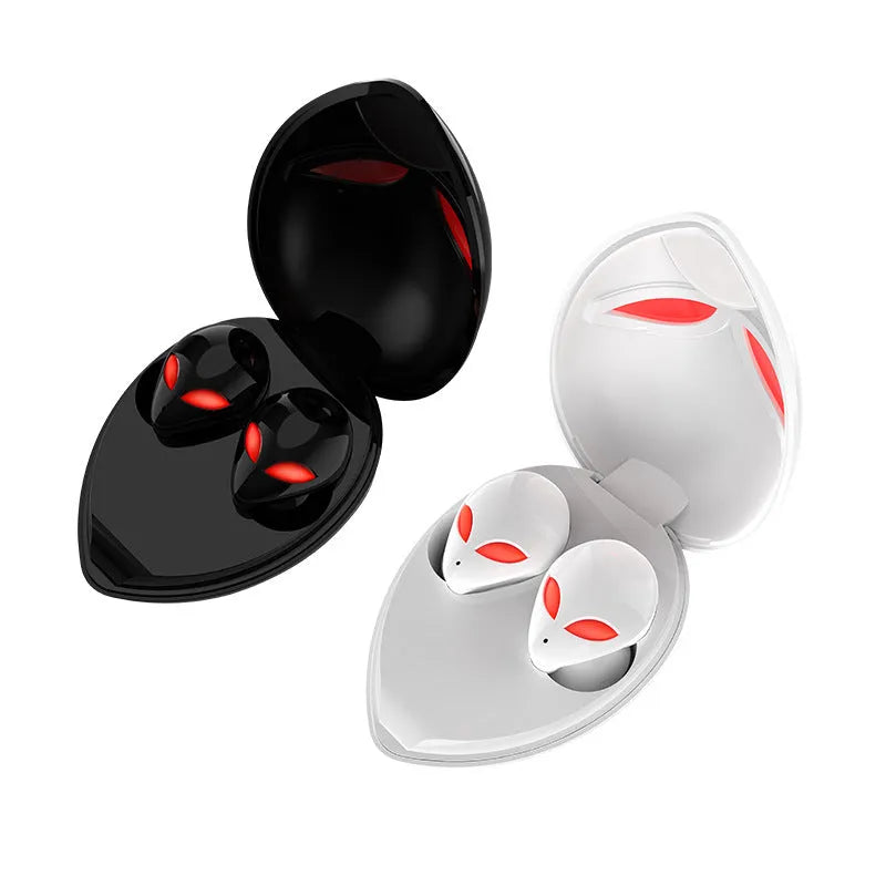 Creative Outer T8 Starman alien-design Bluetooth earbuds with red lighting next to wireless charging case.