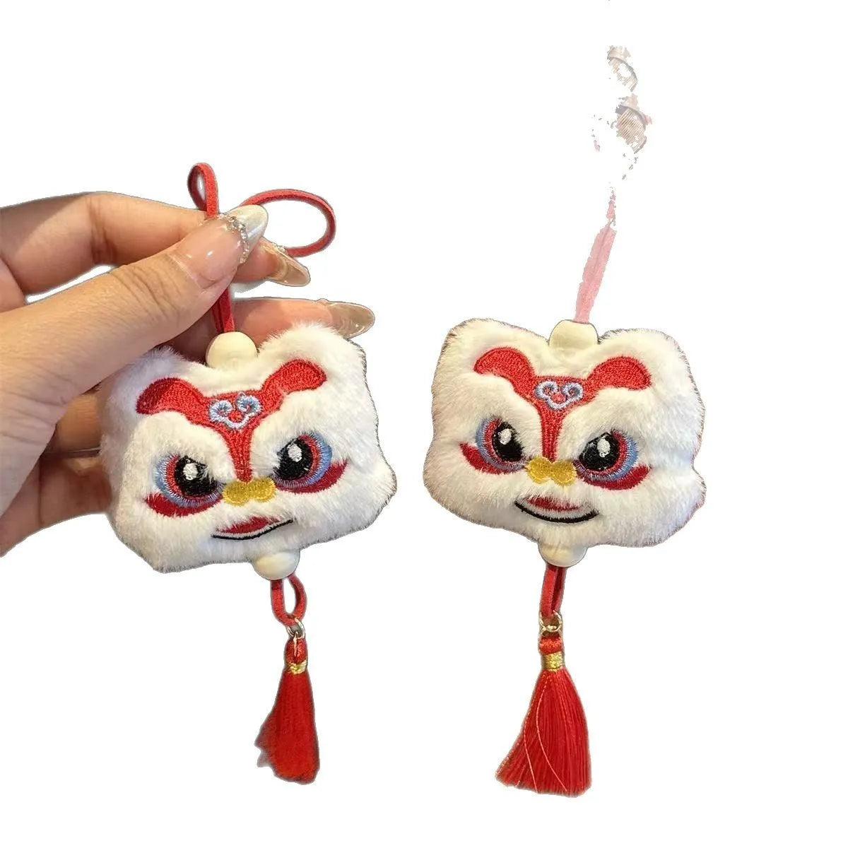 Blue and yellow handmade plush lion keychain ornaments with star stone decoration on white background.
