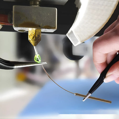 Brass MK8 nozzle and stainless steel cleaning pin for 3D printer maintenance.
